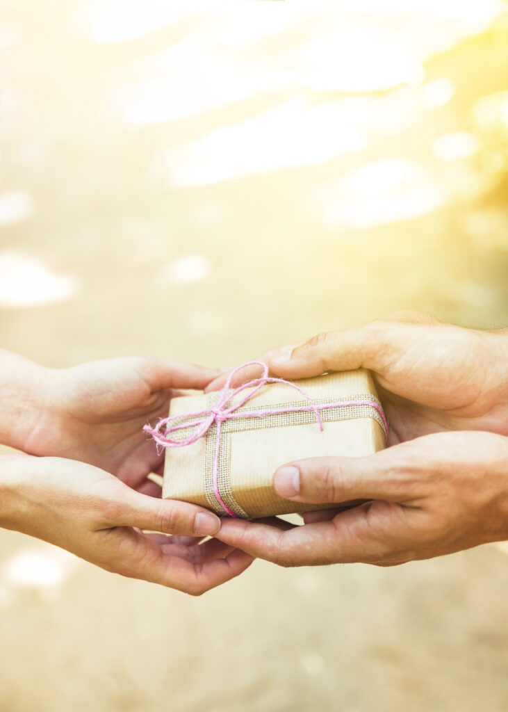 Close Up Couple S Hand Holding Tied Valentine Gift